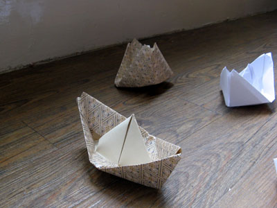 Close-up of “Life Boat”(2012): origami boats installation; wallpaper, copier paper; dimensions variable